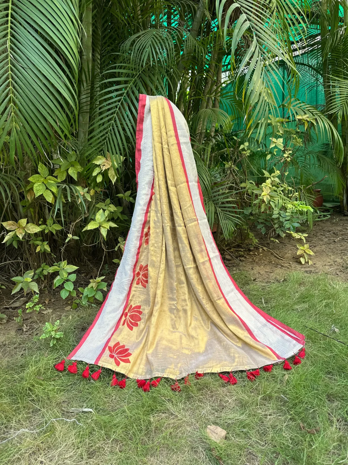 Beige Golden Floral Saree with Red Striped Border and Tassel Detailing